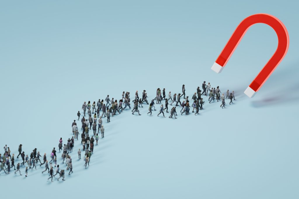 A magnet is attracting people, showing the need for effective lead generation in Atlanta for small business entrepreneurs.