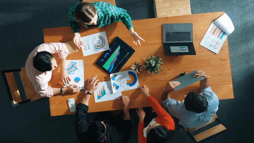 An overhead view of one of many startups in Atlanta reviewing financial data.